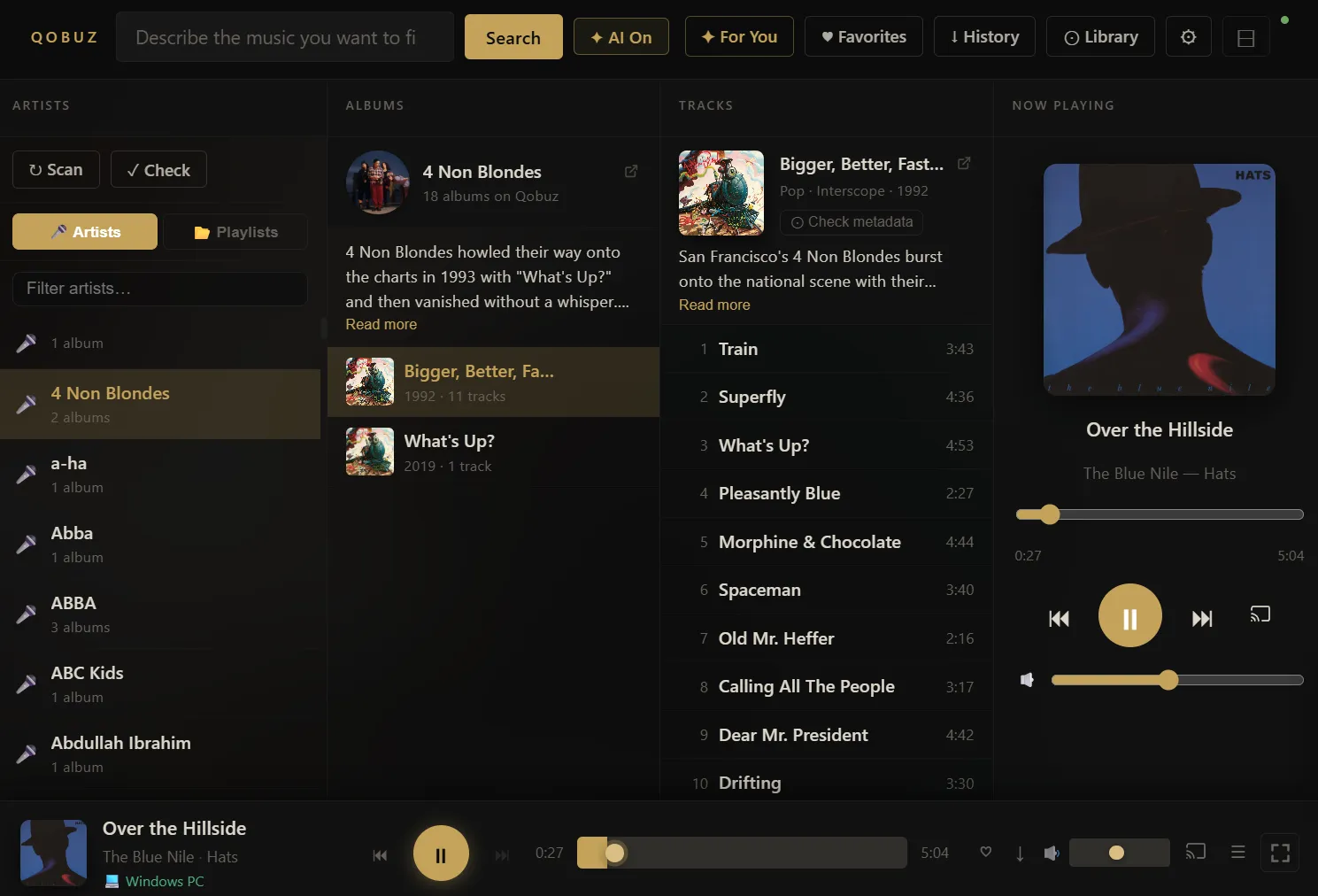 The local library browser — artists, albums, tracks, and now-playing panel side by side